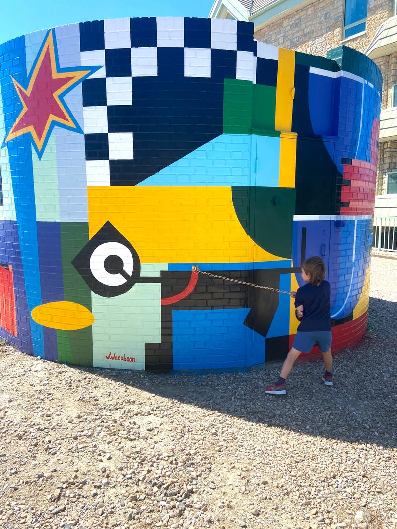 Street-level perspective showing the full mural composition and context.