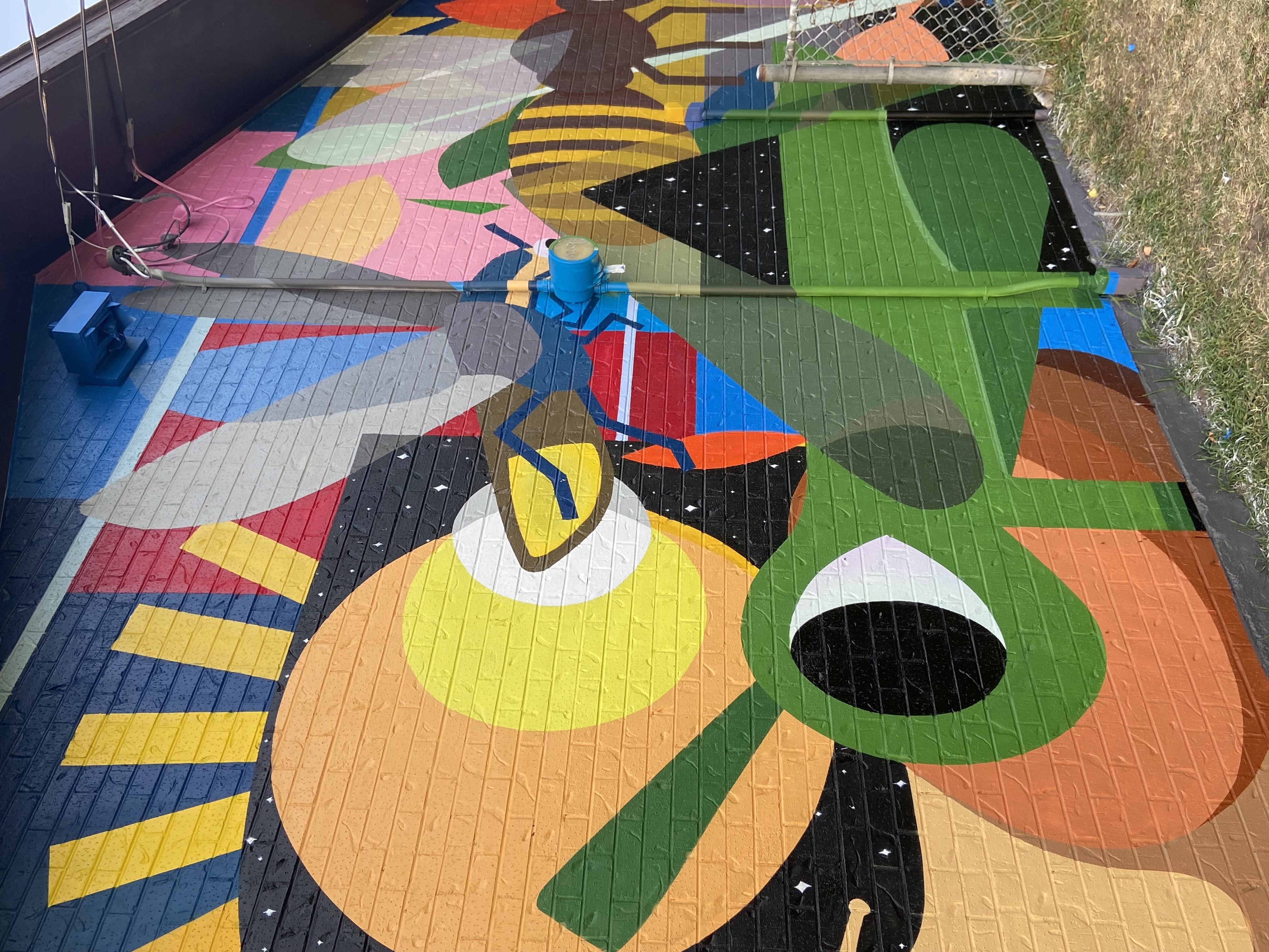 Close-up detail of Park Life mural showing bee and geometric patterns